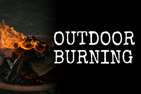 Photo of a fire in a fire pit with a black background and text 