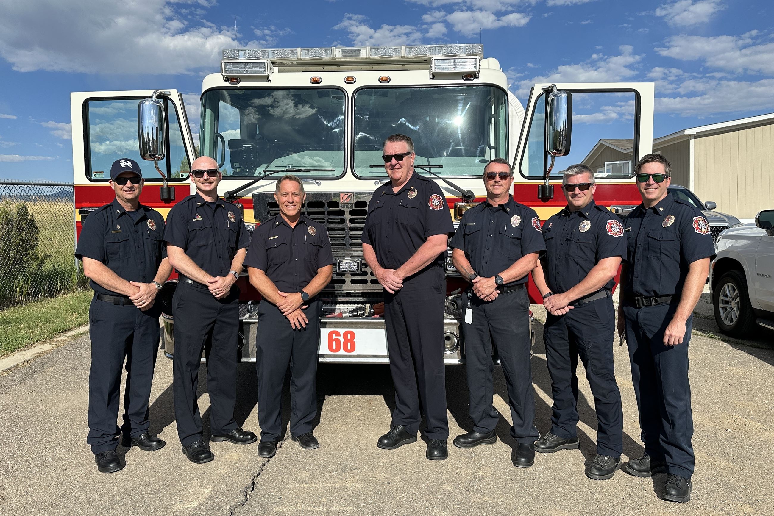 Leaders from North Metro Fire stand in front of the newly operational Engine 68
