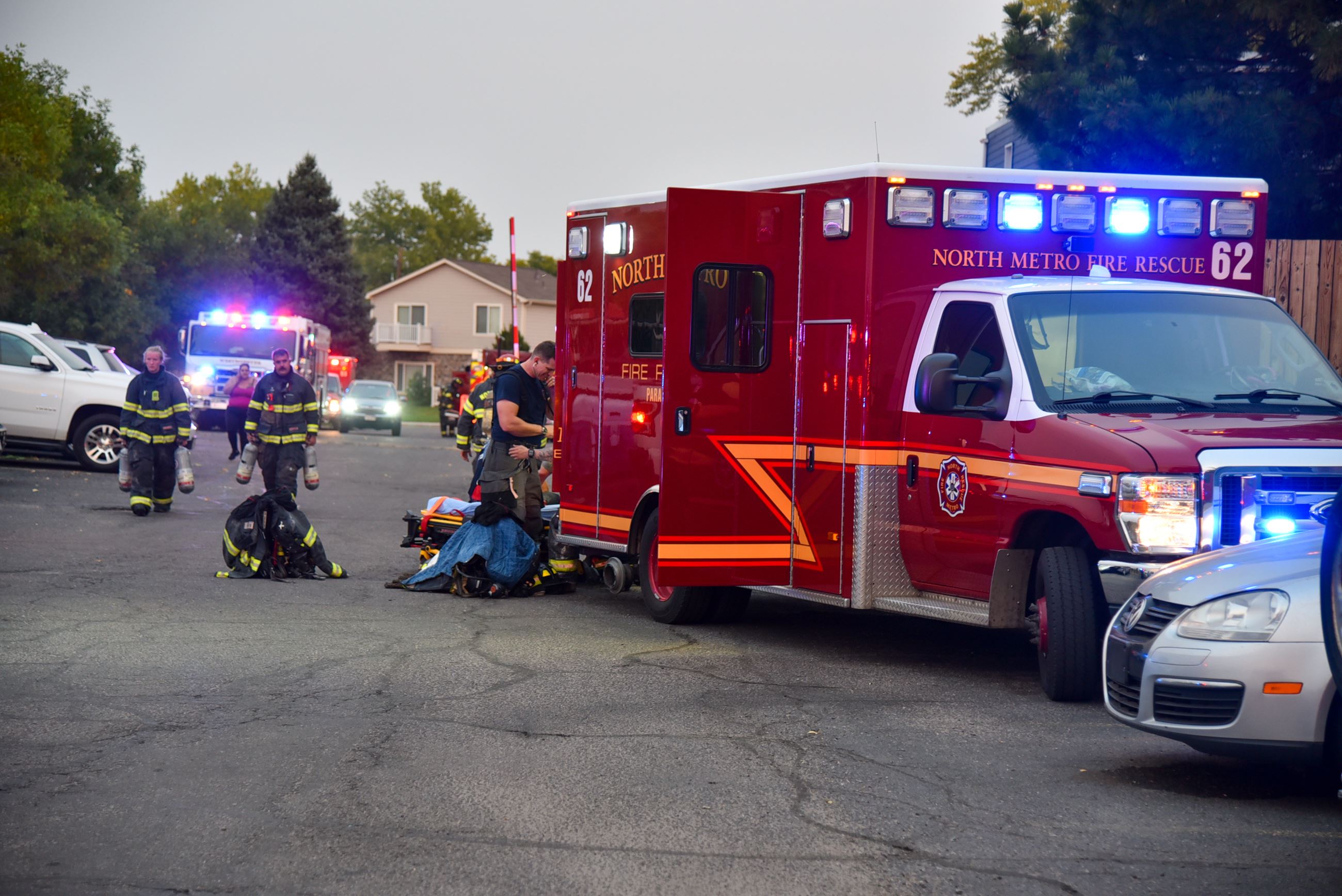 A medic gets ready to check a victim in the back of an ambulance following an apartment fire